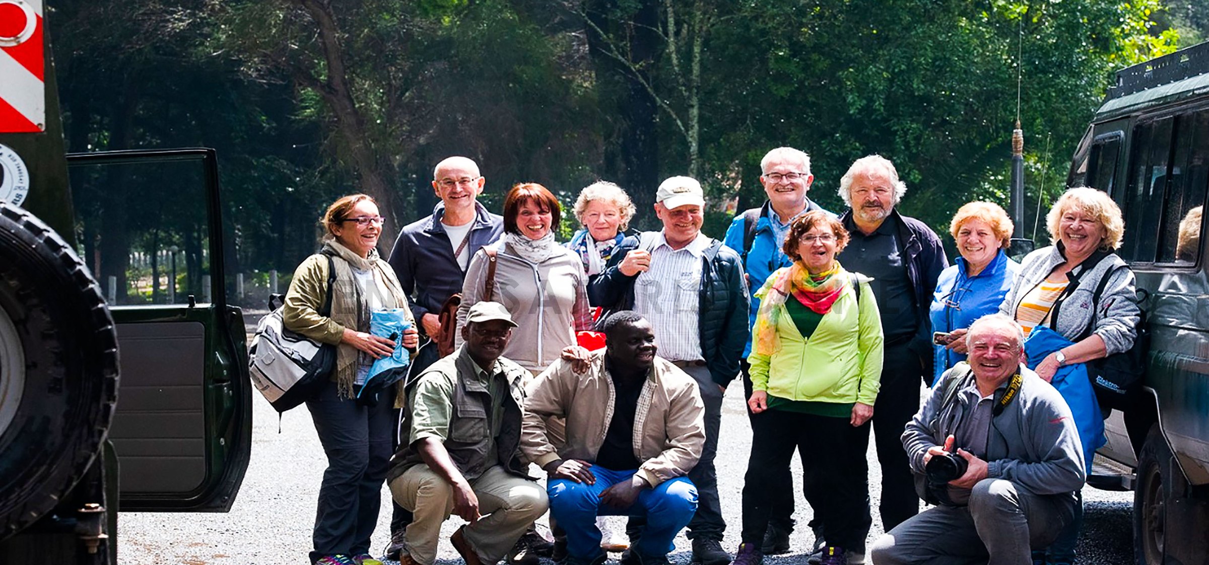 Kenya Safari Centre guests and driver-guides gathered together beside their safari vehicles